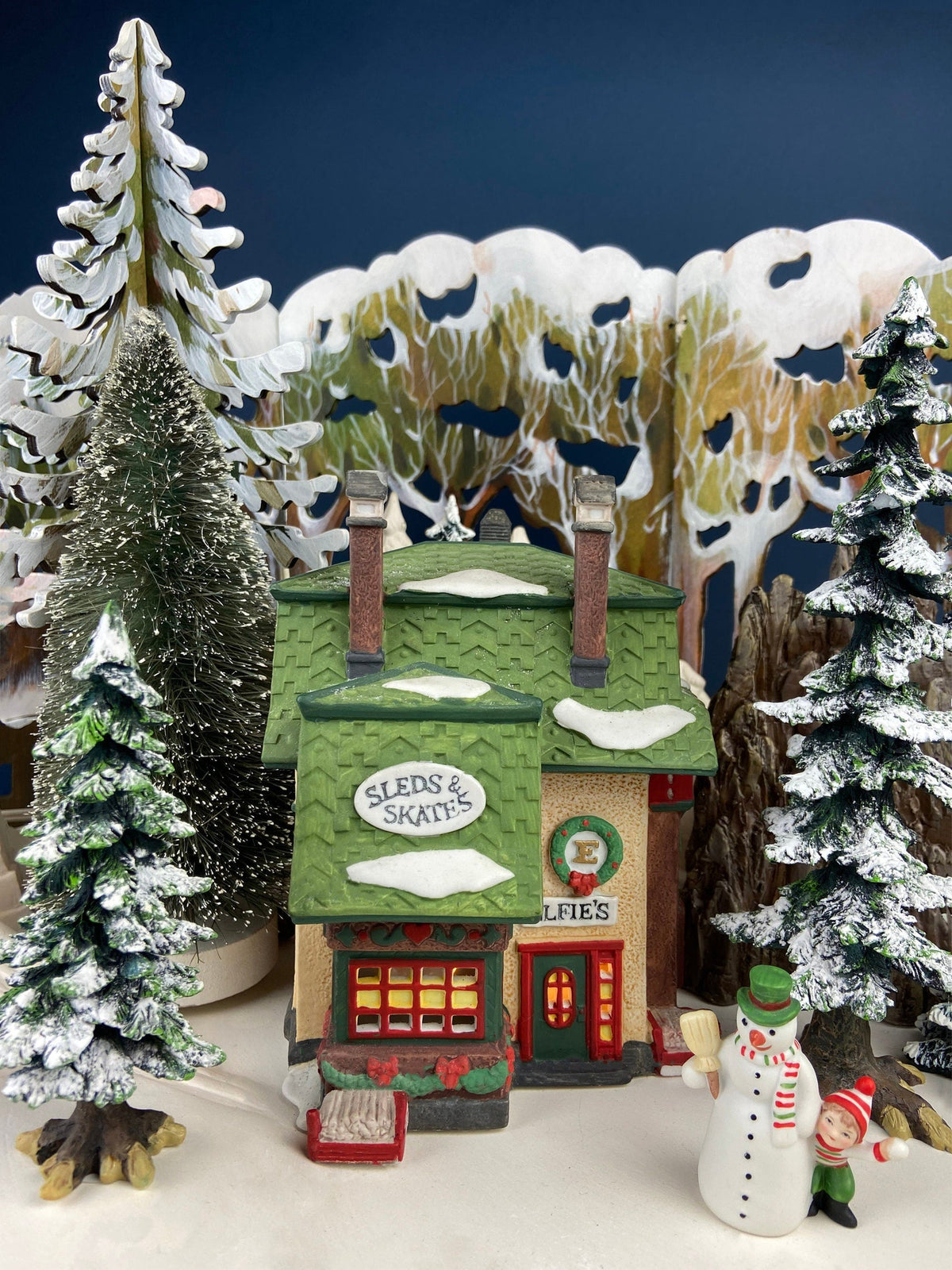 Illuminated House. Elfie's Sleds and Skates. North Pole Series. Hand Painted Porcelain Building with Lights. Christmas Decor.